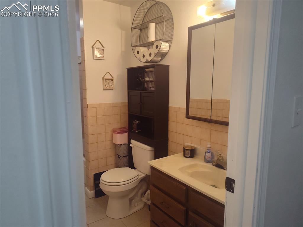 37 Massari Road Pueblo, CO 81001 - Photo 11 of 37 a bathroom with a toilet a sink and mirror