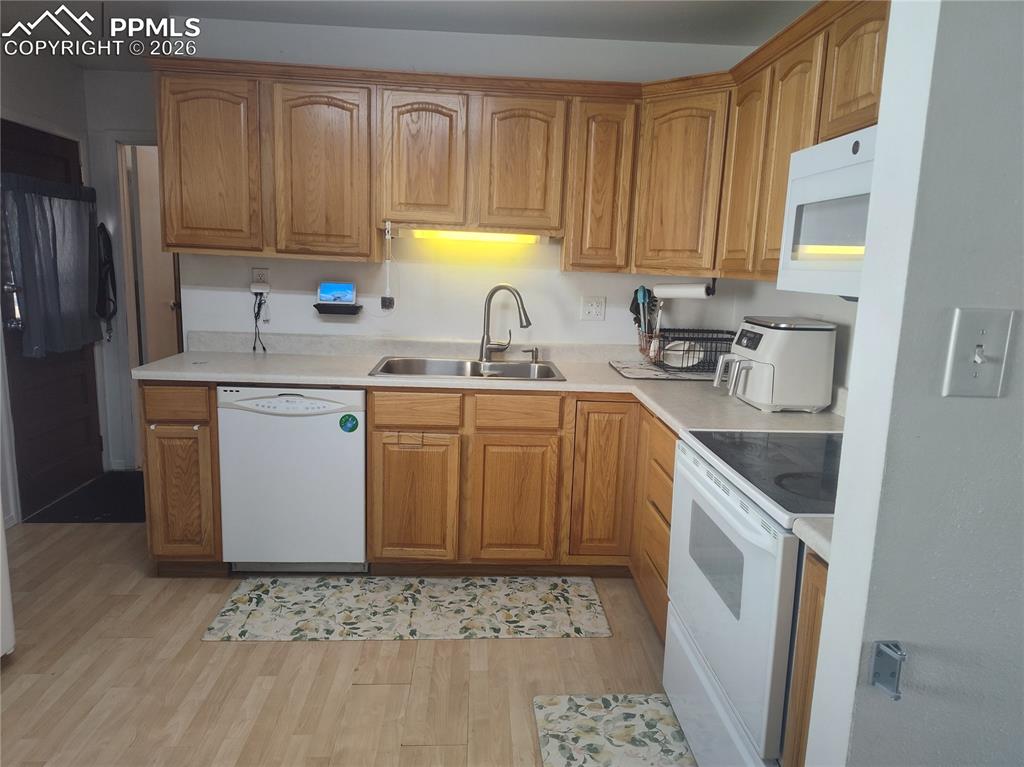 37 Massari Road Pueblo, CO 81001 - Photo 7 of 37 a kitchen with stainless steel appliances granite countertop a sink stove and refrigerator