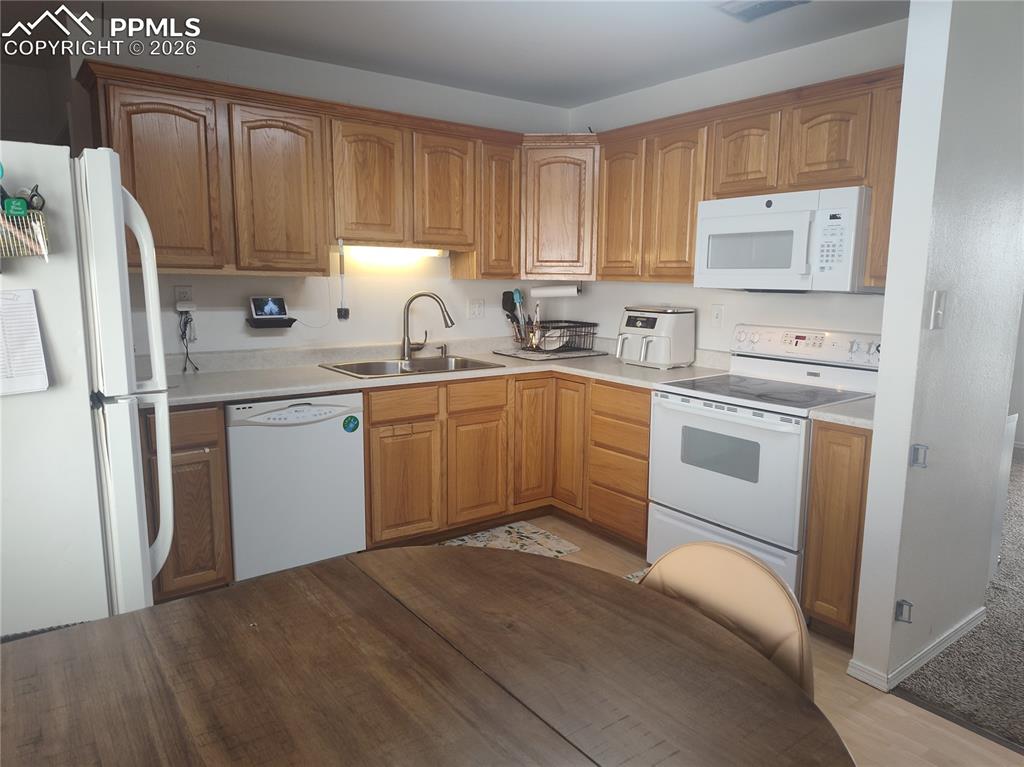 37 Massari Road Pueblo, CO 81001 - Photo 8 of 37 a kitchen with a sink stove and refrigerator