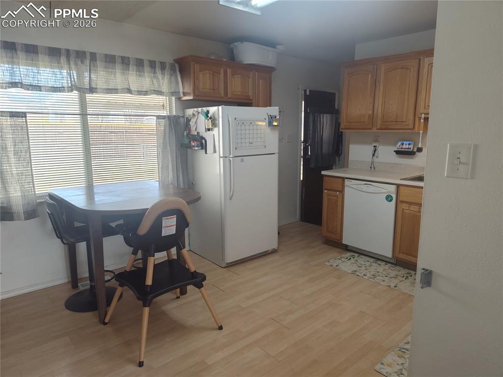 37 Massari Road Pueblo, CO 81001 - Photo 9 of 37 a kitchen with refrigerator cabinets and chairs