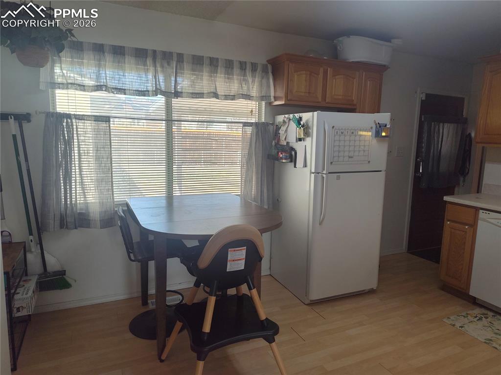 37 Massari Road Pueblo, CO 81001 - Photo 10 of 37 a kitchen with a refrigerator a table and chairs