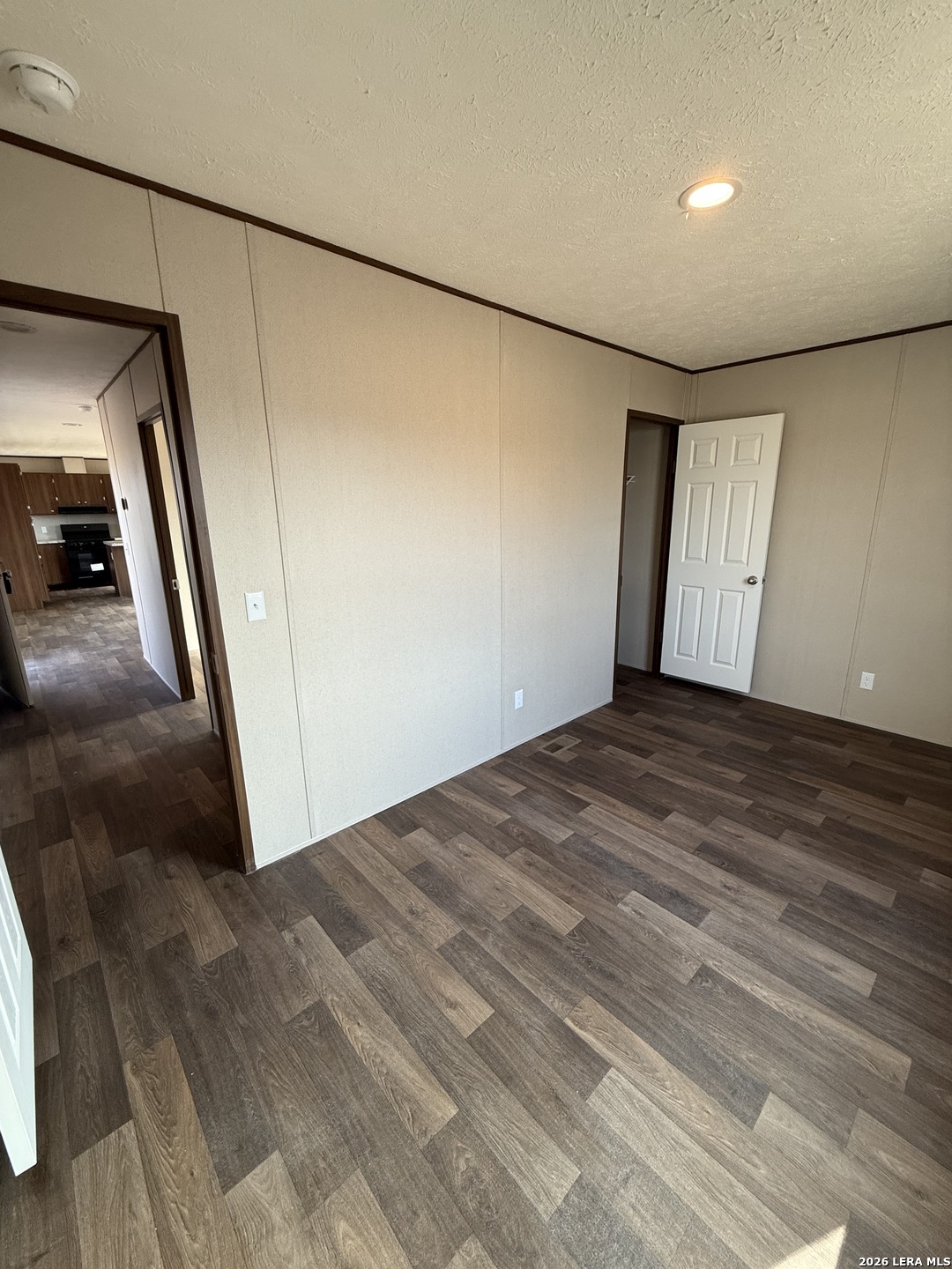 1390 Rendon Road Poteet, TX 78065 - Photo 13 of 22 a view of empty room with wooden floor