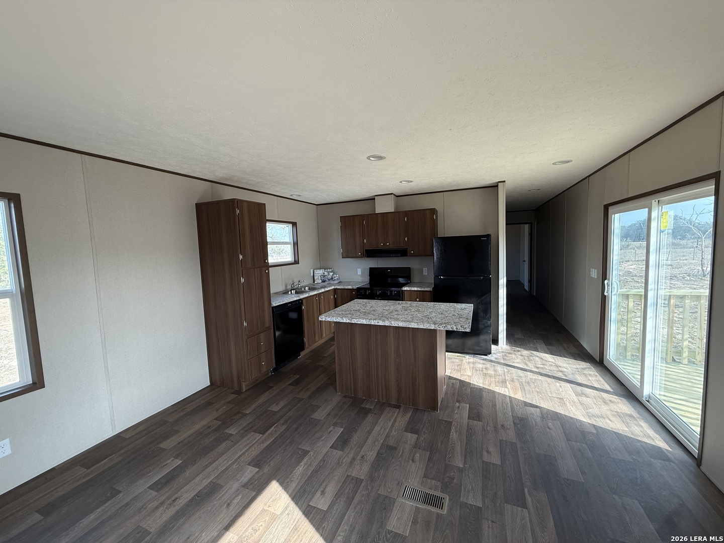 1390 Rendon Road Poteet, TX 78065 - Photo 4 of 22 a view of kitchen with sink refrigerator and microwave