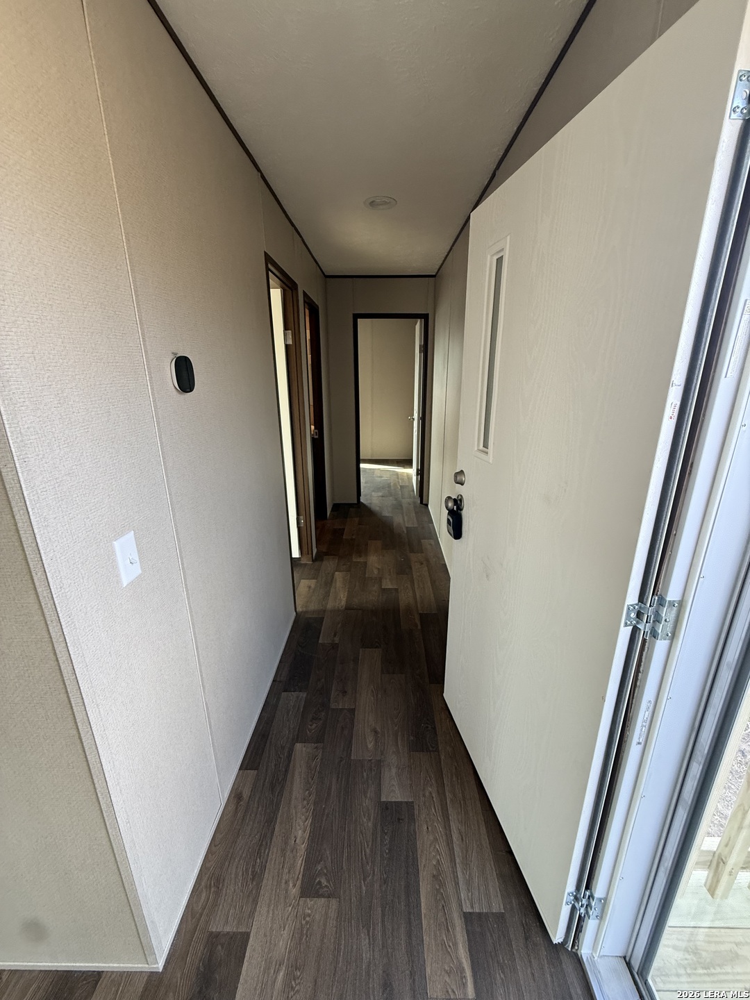 1390 Rendon Road Poteet, TX 78065 - Photo 9 of 22 a view of a hallway with wooden floor and staircase