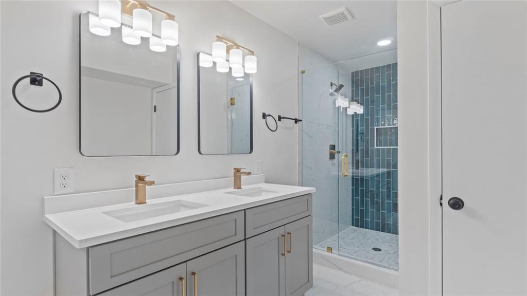 4088 Vale Court Decatur, GA 30035 - Photo 4 of 30 a bathroom with a double vanity sink mirror and shower
