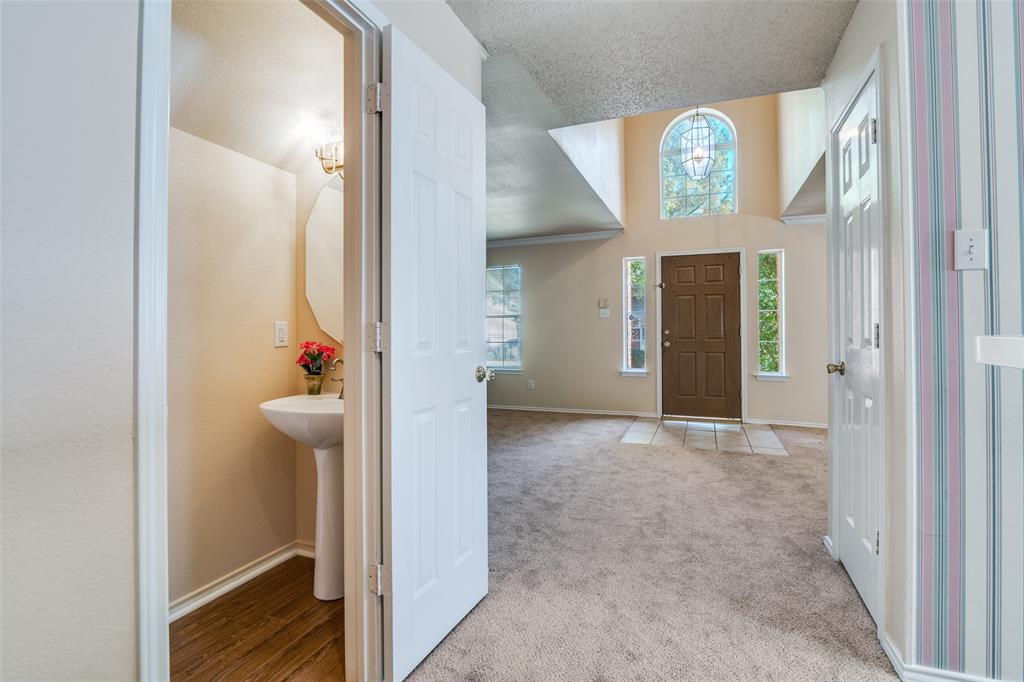 1202 Morrow Lane Allen, TX 75002 - Photo 14 of 35 Entrance foyer featuring carpet floors and a courtesy half bath