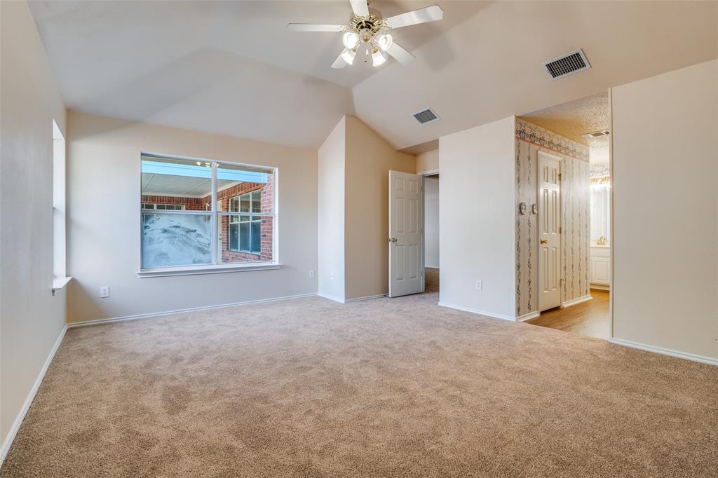 1202 Morrow Lane Allen, TX 75002 - Photo 17 of 35 Unfurnished bedroom featuring ceiling fan, light carpet, vaulted ceiling, and ensuite bathroom