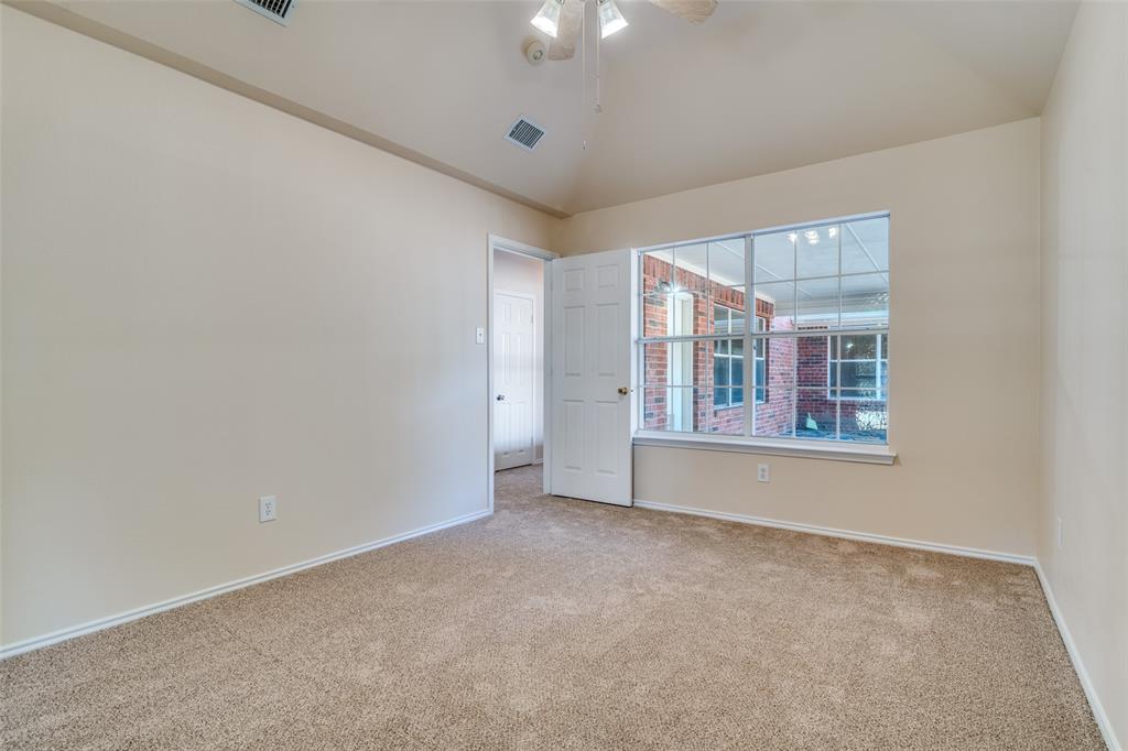 1202 Morrow Lane Allen, TX 75002 - Photo 19 of 35 Primary bedroom featuring vaulted ceiling, carpet floors, and a ceiling fan