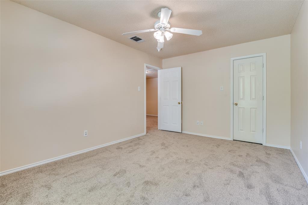1202 Morrow Lane Allen, TX 75002 - Photo 24 of 35 Unfurnished bedroom featuring carpet, ceiling fan, and a textured ceiling