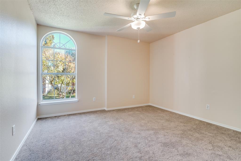 1202 Morrow Lane Allen, TX 75002 - Photo 27 of 35 Unfurnished room featuring light colored carpet, a textured ceiling, and ceiling fan