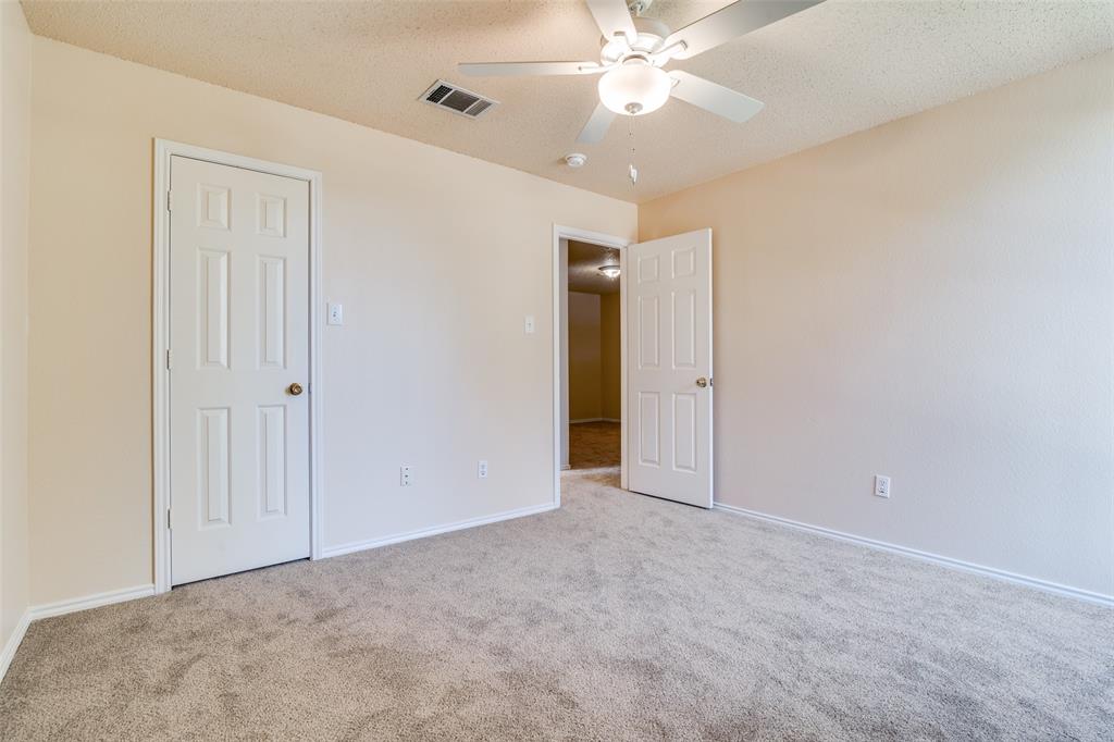 1202 Morrow Lane Allen, TX 75002 - Photo 28 of 35 Unfurnished bedroom featuring a textured ceiling, light carpet, and ceiling fan
