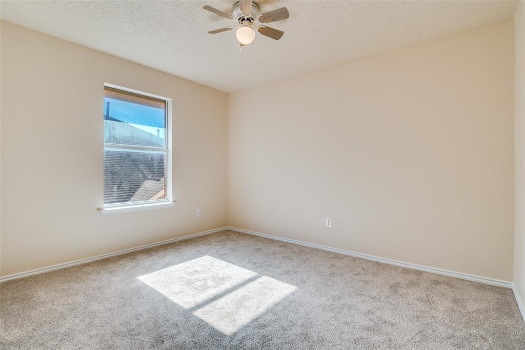 1202 Morrow Lane Allen, TX 75002 - Photo 29 of 35 Carpeted spare bedroom featuring a textured ceiling and ceiling fan