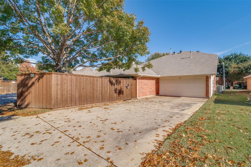 1202 Morrow Lane Allen, TX 75002 - Photo 34 of 35 View of property with reaccess concrete driveway, brick siding, a garage, and roof with shingles