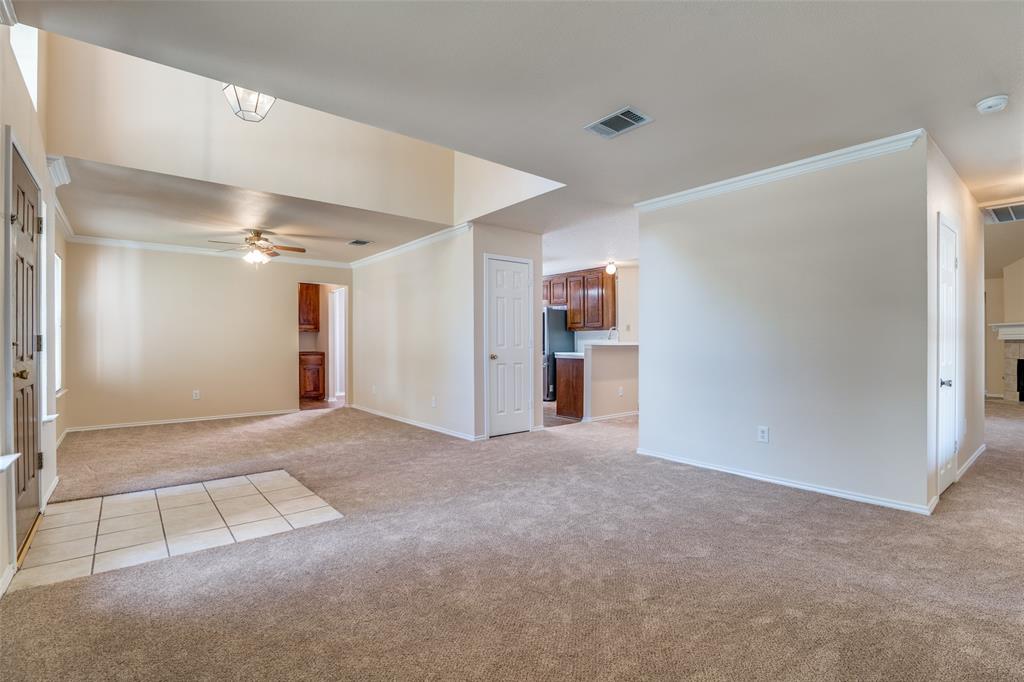 1202 Morrow Lane Allen, TX 75002 - Photo 5 of 35 Empty room featuring crown molding, light carpet, and ceiling fan