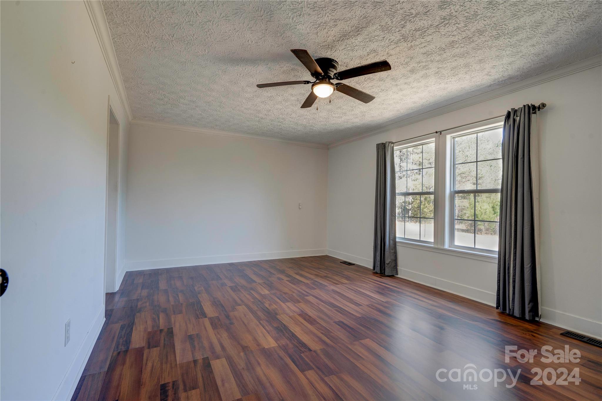 441 Dills Road Rutherfordton, NC 28139 - Photo 19 of 47 an empty room with wooden floor fan and windows