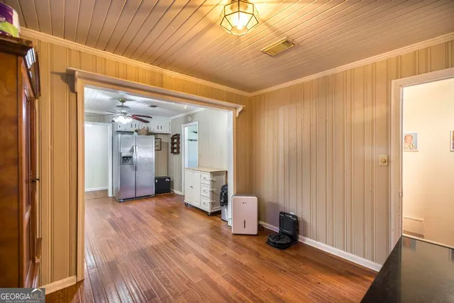 a view of a hallway with wooden floor