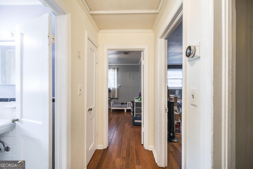 620 Pine Ridge Street Perry, GA 31069 - Photo 12 of 28 a view of a hallway with wooden floor and a living room
