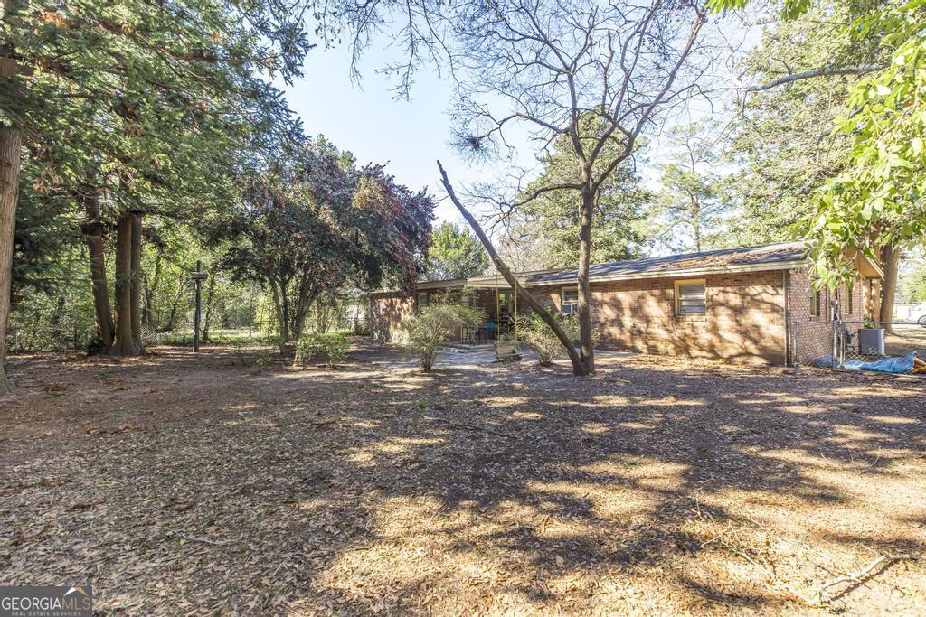 620 Pine Ridge Street Perry, GA 31069 - Photo 26 of 28 a view of a yard with a tree