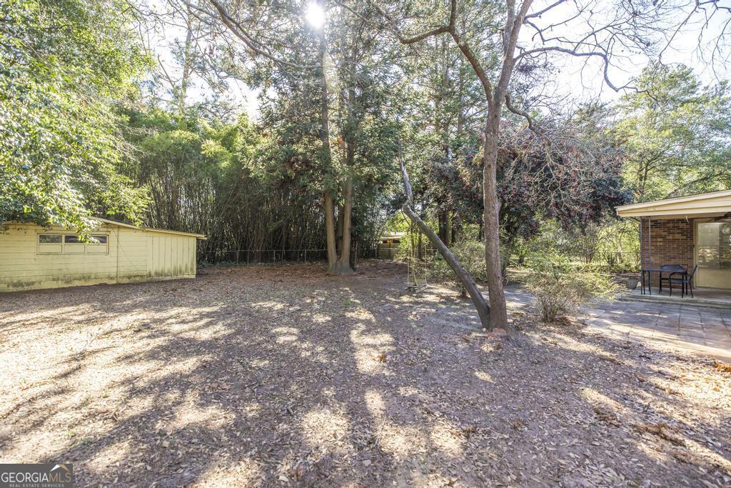 620 Pine Ridge Street Perry, GA 31069 - Photo 28 of 28 a view of a backyard with large trees
