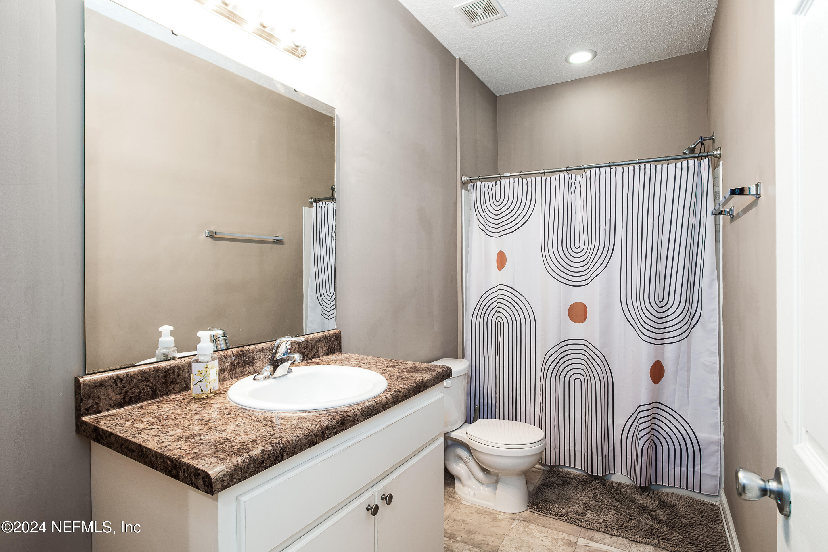 87241 Lents Road Yulee, FL 32097 - Photo 14 of 19 a bathroom with a granite countertop sink and a mirror