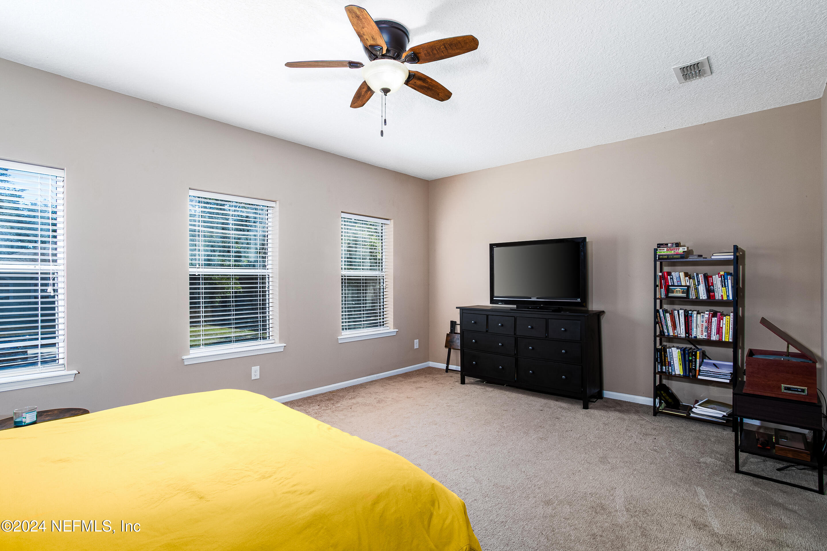 87241 Lents Road Yulee, FL 32097 - Photo 16 of 19 a bedroom with furniture and a flat screen tv