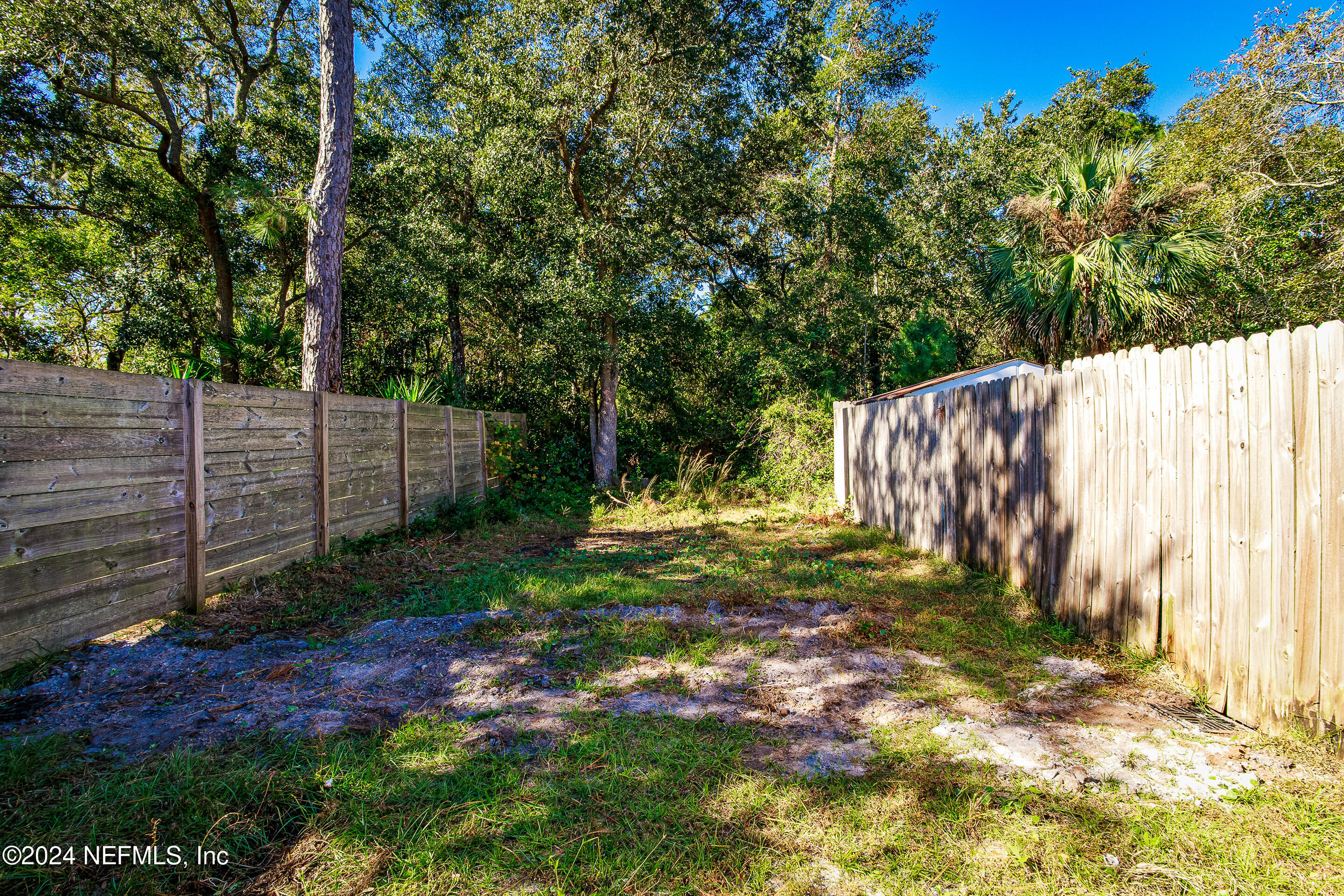 87241 Lents Road Yulee, FL 32097 - Photo 17 of 19 a view of a yard with wooden fence