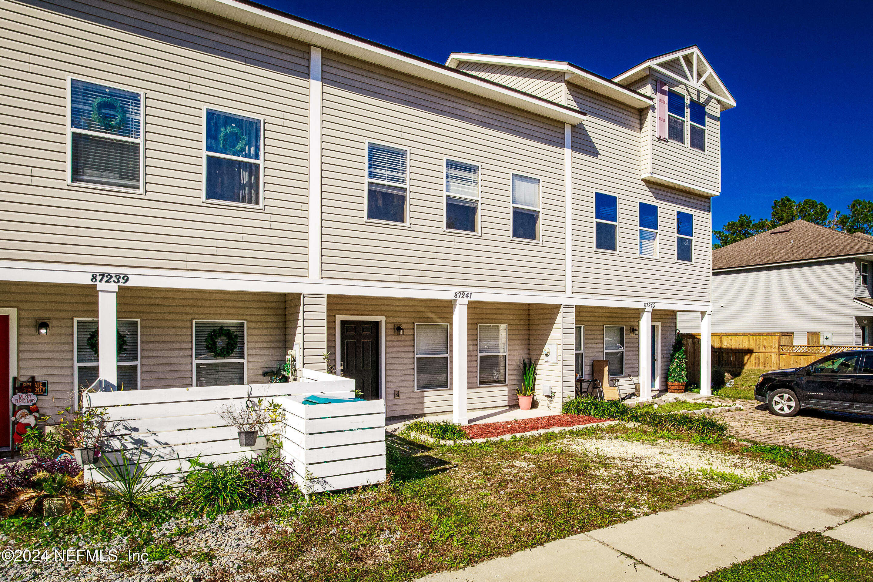 87241 Lents Road Yulee, FL 32097 - Photo 3 of 19 a view of a white house with a large windows