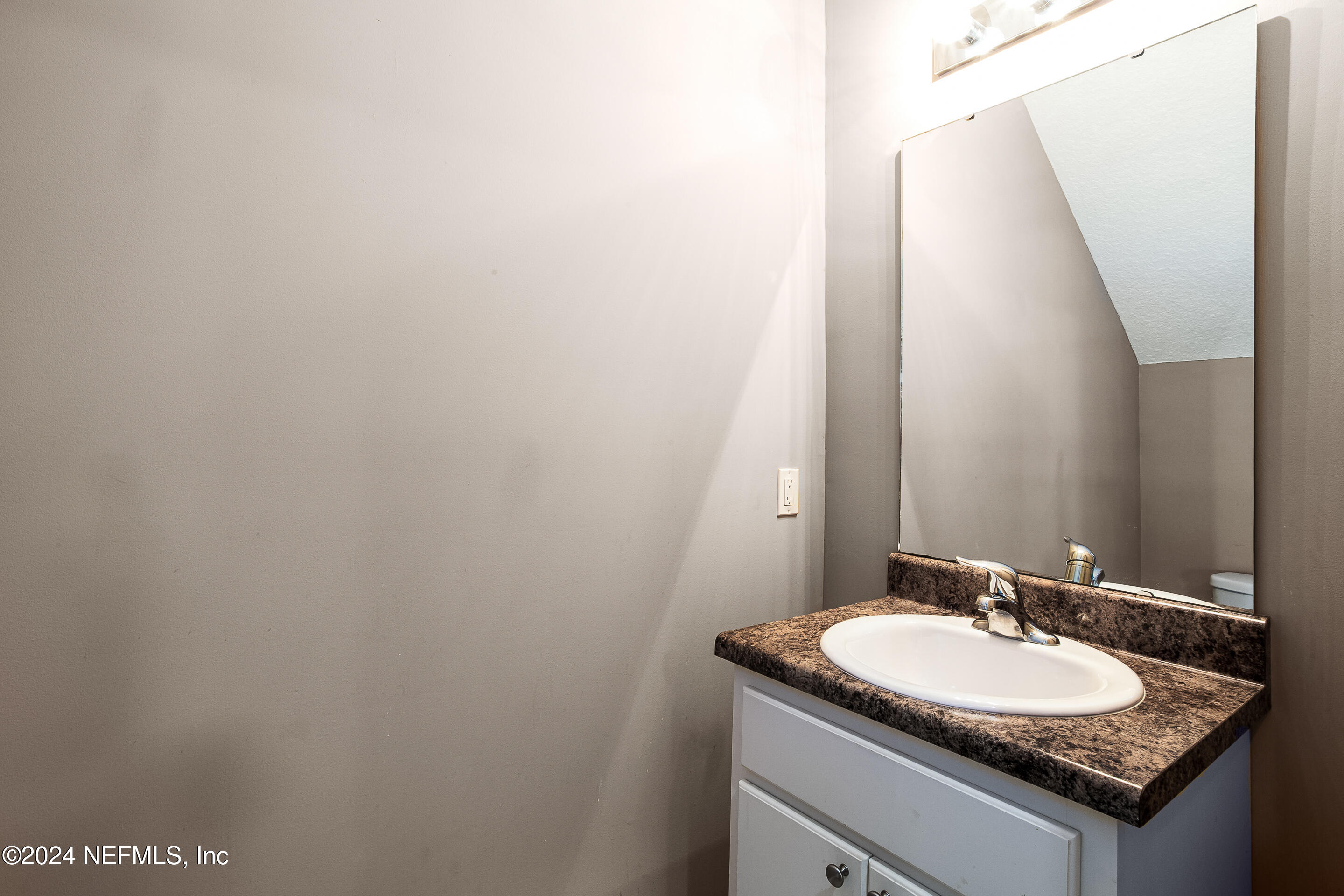 87241 Lents Road Yulee, FL 32097 - Photo 8 of 19 a bathroom with a granite countertop sink and a mirror