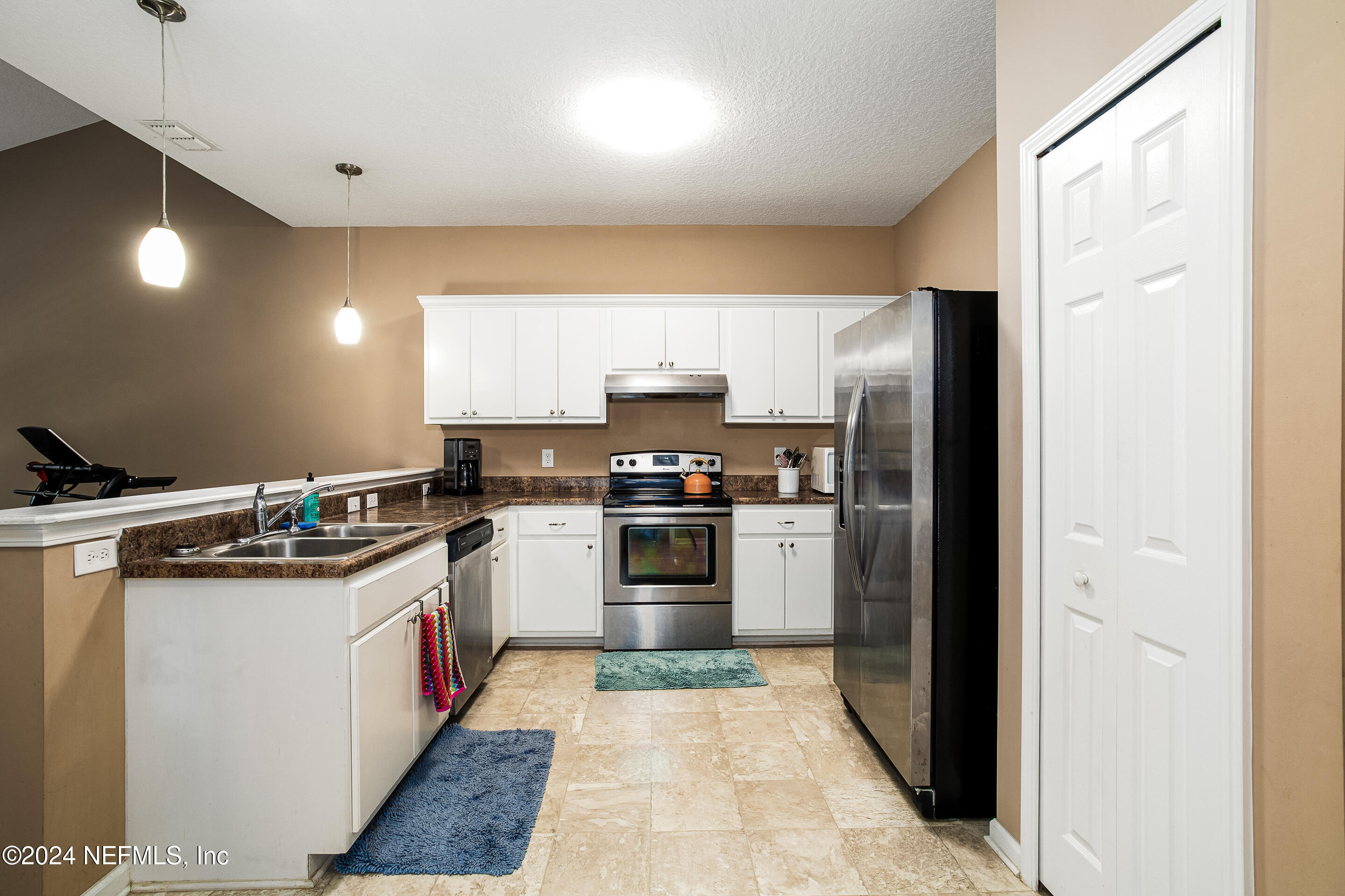87241 Lents Road Yulee, FL 32097 - Photo 9 of 19 a kitchen with stainless steel appliances granite countertop a stove a sink and a refrigerator