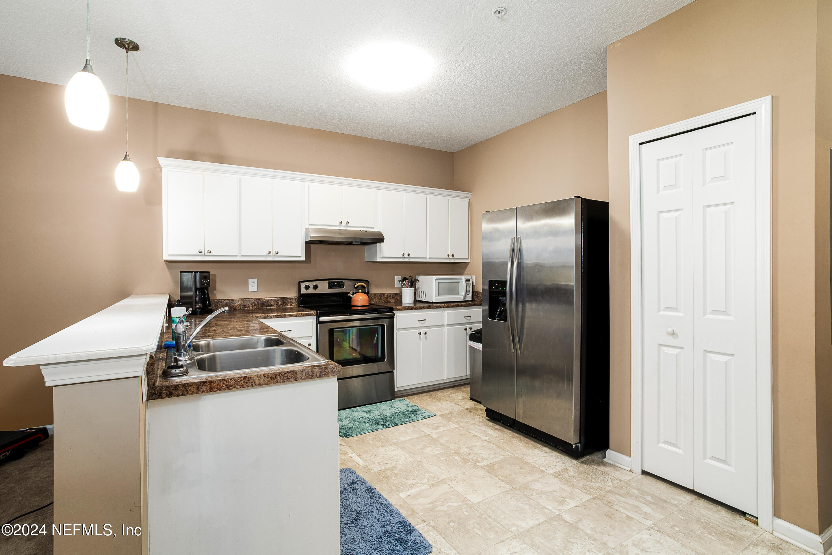 87241 Lents Road Yulee, FL 32097 - Photo 10 of 19 a kitchen with a refrigerator sink and stainless steel appliances