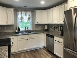 73 County Road Freetown, MA 02717 - Photo 3 of 11 a kitchen with granite countertop white cabinets white appliances a sink and a window