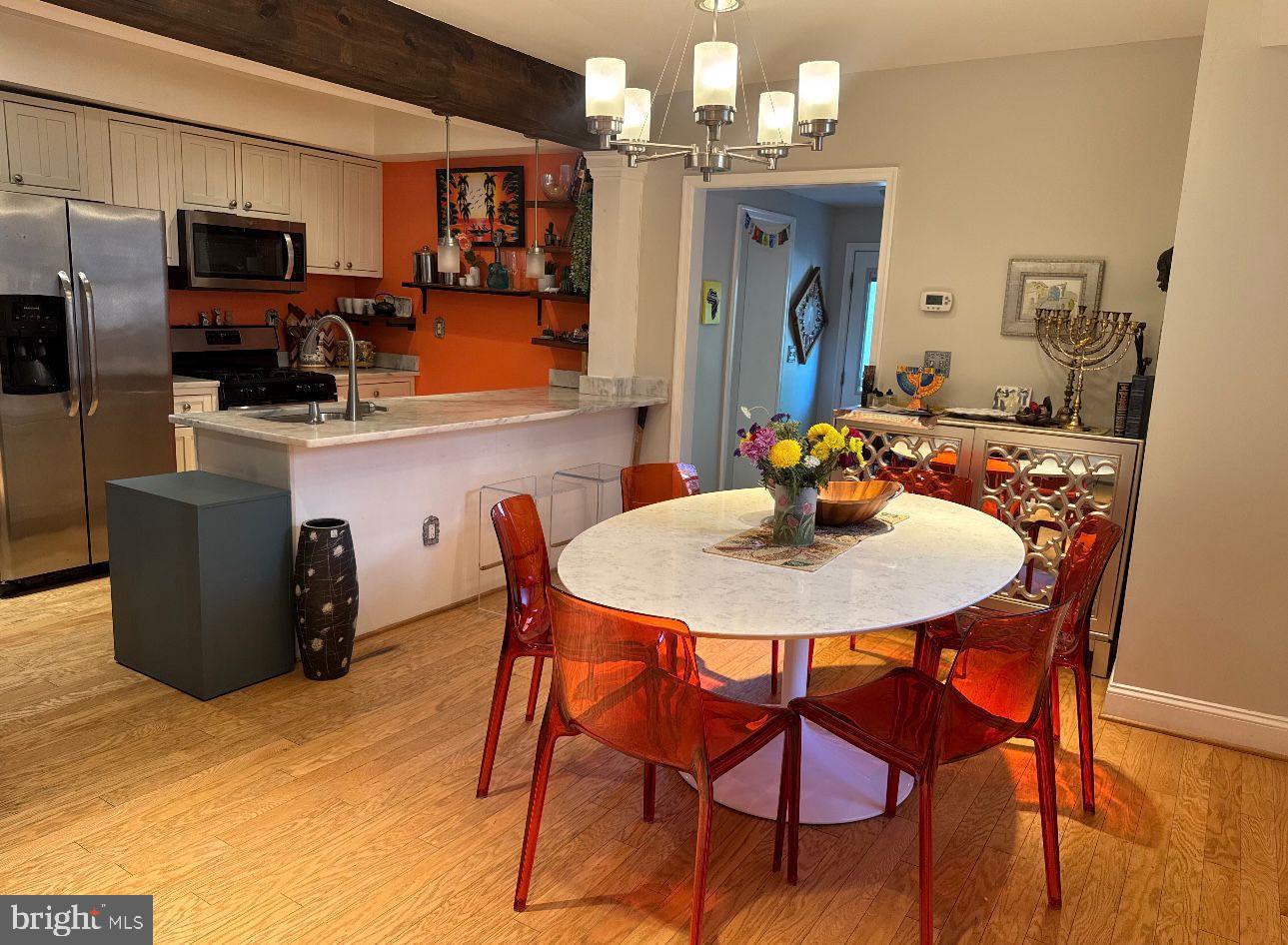 4818 Sheriff Road Northeast Washington, DC 20019 - Photo 12 of 36 a kitchen with stainless steel appliances a dining table and chairs