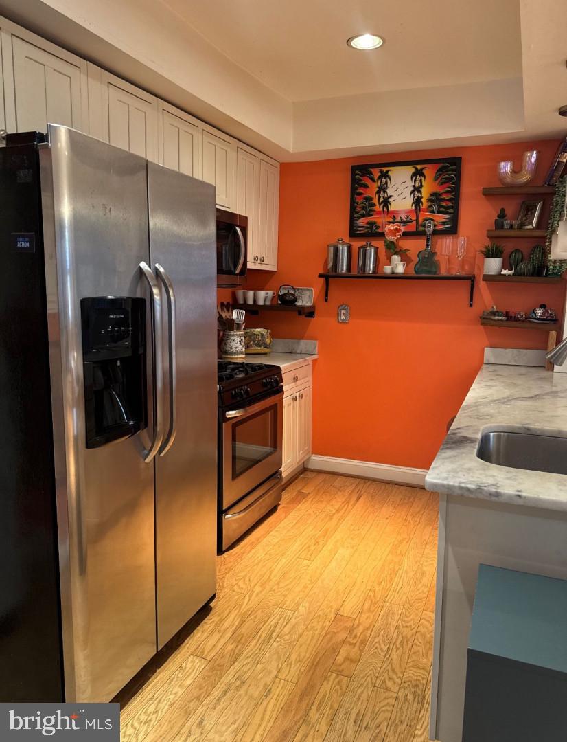 4818 Sheriff Road Northeast Washington, DC 20019 - Photo 13 of 36 a kitchen with stainless steel appliances granite countertop a refrigerator and a sink
