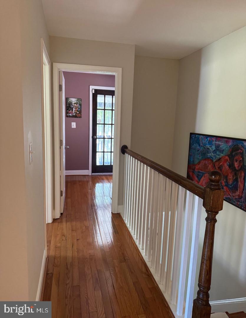 4818 Sheriff Road Northeast Washington, DC 20019 - Photo 20 of 36 a view of a hallway with wooden floor and stairs