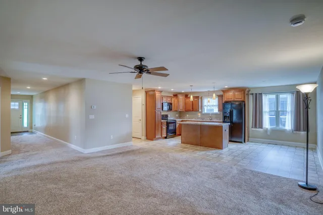 a large kitchen with granite countertop a sink and a stove
