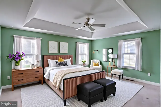 a bedroom with a large bed wooden floor and windows