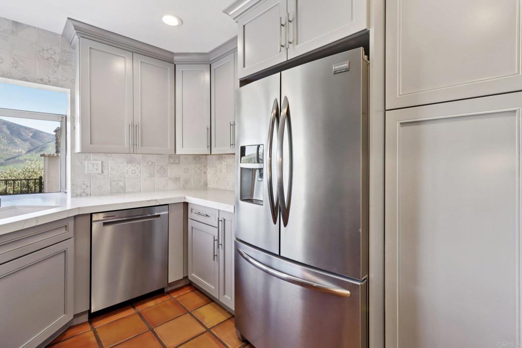 9863 Avenida Colino Spring Valley, CA 91977 - Photo 11 of 54 a white refrigerator freezer sitting inside of a kitchen