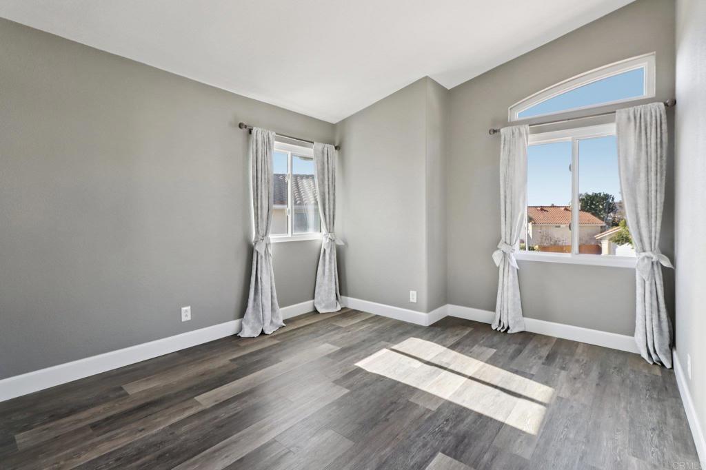9863 Avenida Colino Spring Valley, CA 91977 - Photo 23 of 54 a view of a room with wooden floor and white walls