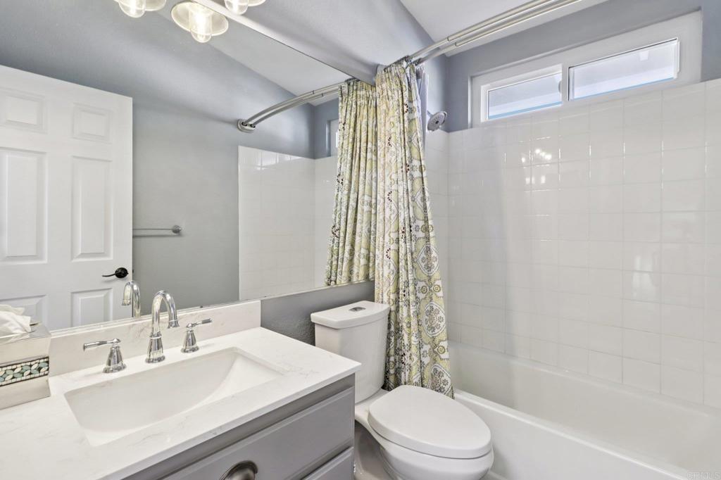 9863 Avenida Colino Spring Valley, CA 91977 - Photo 25 of 54 a bathroom with a sink a toilet and shower