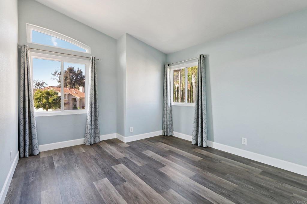 9863 Avenida Colino Spring Valley, CA 91977 - Photo 26 of 54 an empty room with wooden floor and a window