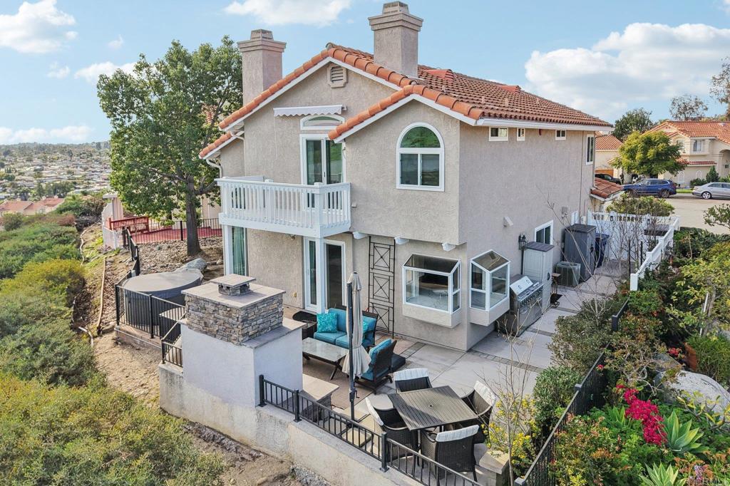 9863 Avenida Colino Spring Valley, CA 91977 - Photo 39 of 54 a view of a patio with couches table and chairs and potted plants