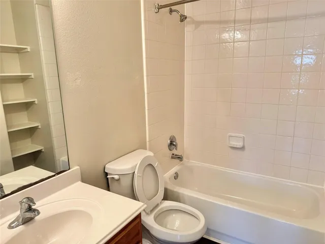 a bathroom with a toilet a sink and bathtub
