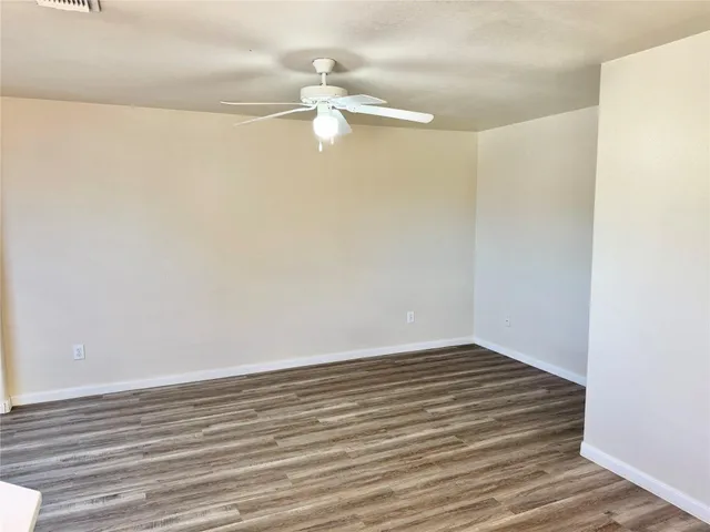 a view of a room with wooden floor