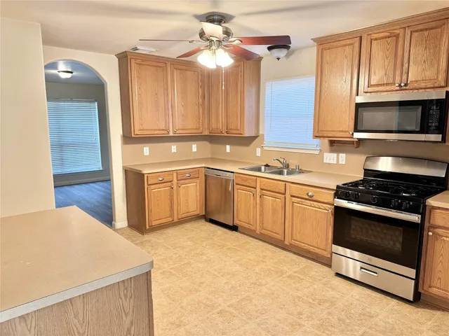 a kitchen with stainless steel appliances white cabinets and a sink