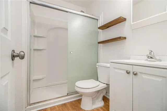 a bathroom with a toilet and a shower