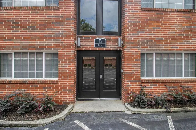 a view of a brick house with many windows
