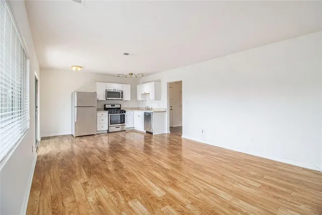 a view of a kitchen with a sink and a refrigerator