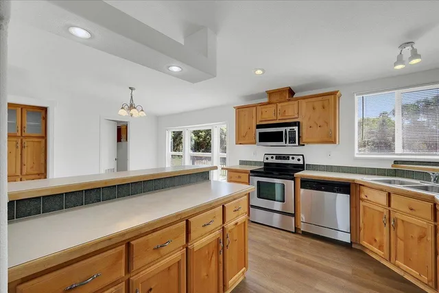 an aerial view of a house with a garden and lake view