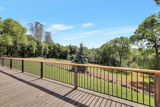 a view of a balcony with wooden fence and floor