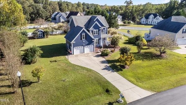 an aerial view of a house with a swimming pool